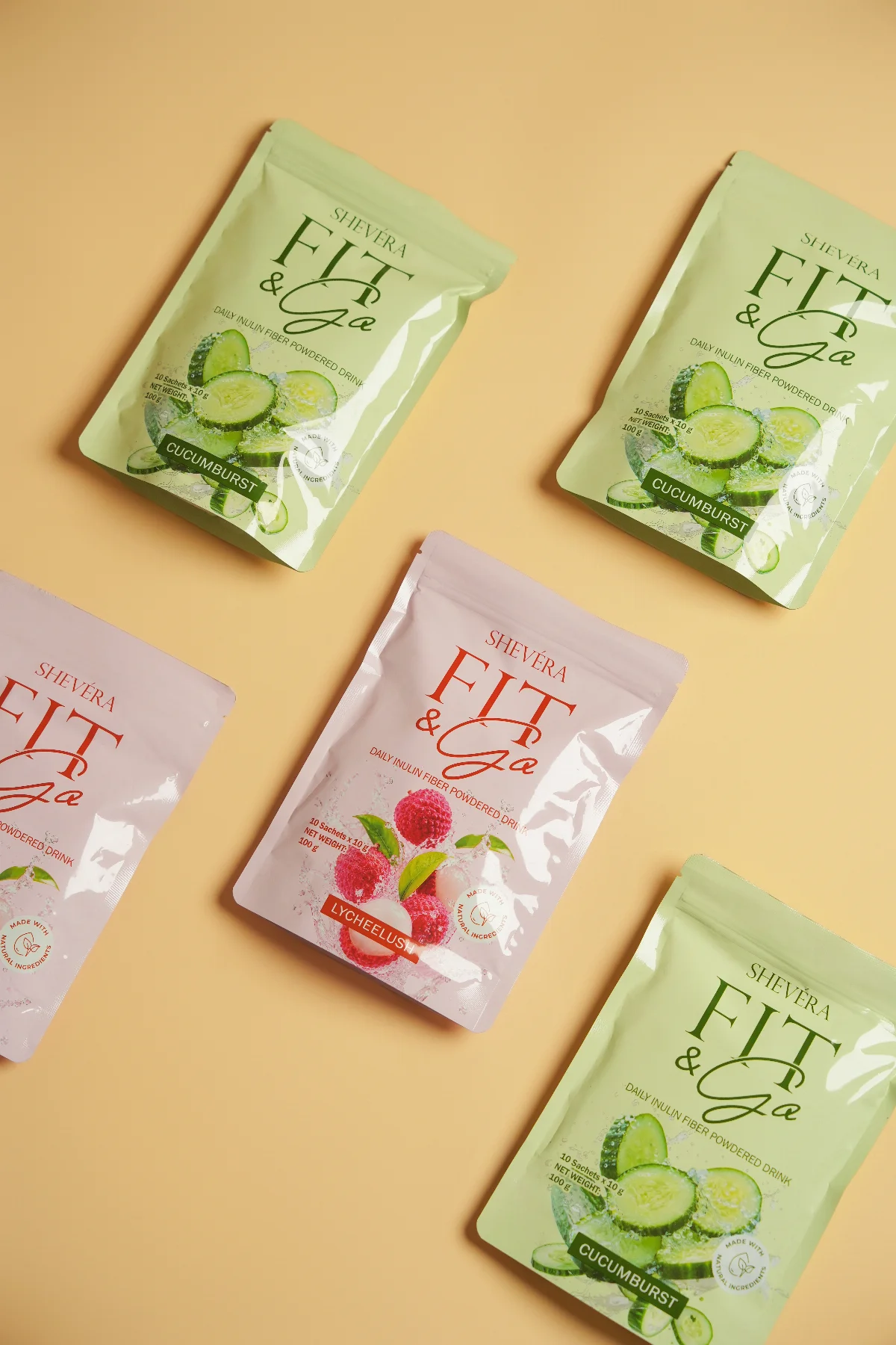 Shevéra Fit and Go cucumber and lychee packs arranged on a warm yellow background